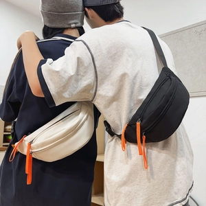 Waterproof crossbody chest bag in black and off-white with vibrant orange zippers