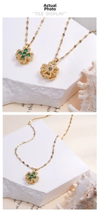 Detail of golden clover pendant with green zircons and rotating镂空 design on back