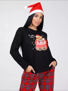 Detailed view of long-sleeve Christmas pajamas with festive bear print and plaid pants