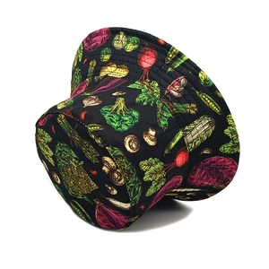 Close-up of black canvas bucket hat with vibrant hand-painted vegetable patterns