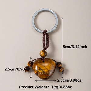 Detailed view of handmade tiger eye stone heart keychain with braided cord and size markings