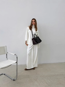 Women's white high-neck knit sweater with split cuffs and matching wide-leg trousers