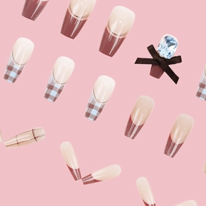 Retro blue and brown plaid press-on nails with sparkling diamond bows on pink background