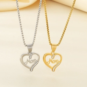 Close-up of gold and silver heart pendants with Mom lettering and sparkling zircons