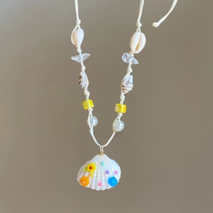 Detail view of handmade shell pendant necklace with colorful beads, length about 66cm
