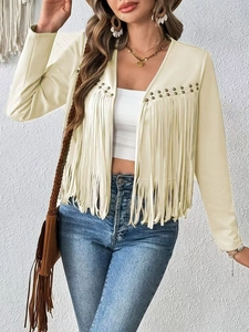 Close-up of fringe details and metallic stud embellishments on a cream suede jacket