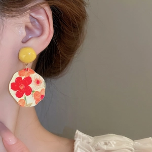 Artistic oil painting sunflower drop earrings shown on model with floral textures