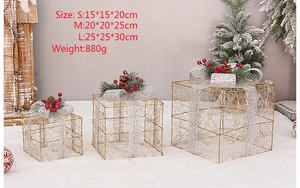 Three gold metal wire Christmas gift boxes in S M L sizes for holiday scene decoration