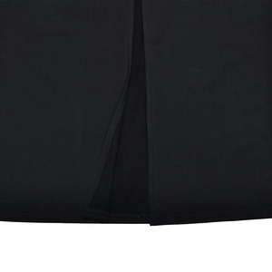Close-up detail of the hem slit and high-elastic fabric texture of the black dress