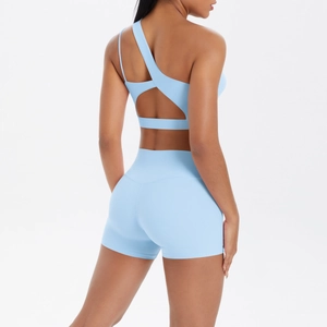 Rear view of light blue one-shoulder sports bra with cross hollow out back and yoga shorts