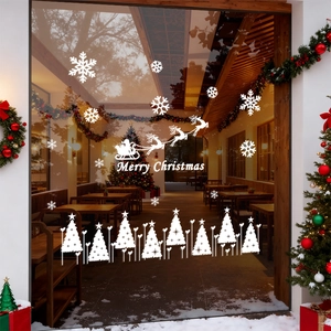 White Merry Christmas window stickers featuring Santa Claus, reindeer and snowflakes on glass