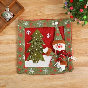 Festive Christmas snowman and tree cushion cover on a rustic wooden background