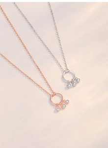 Detail of rose gold and silver tassel necklaces with sparkling crystal pendants