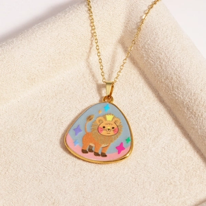 Close-up of golden triangle lion pendant necklace on a beige plush fabric background