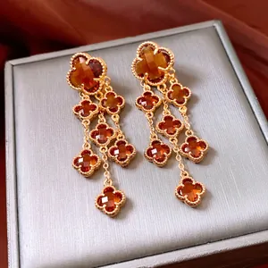 Vintage 18k gold plated clover tassel earrings with amber glass and beaded edges
