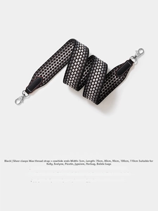 Detail of 5cm wide black woven shoulder strap with leather ends and silver metal buckle