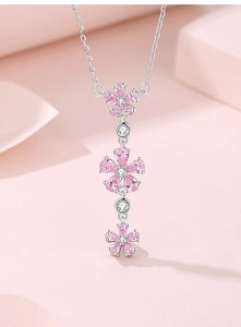 Macro shot of S925 silver necklace with pink enamel flowers and sparkling zircon details