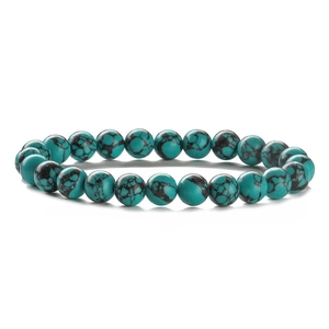 Detailed view of turquoise beaded bracelet with natural black mineral veins and textures