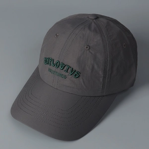 Detail of dark grey quick-dry baseball cap featuring green 3D embroidery and durable stitching