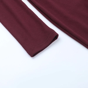 Detailed close-up of double-stitched sleeve cuffs on a burgundy bodycon dress