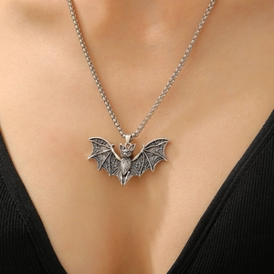 Close-up of silver bat pendant necklace worn by a model for a gothic punk style look