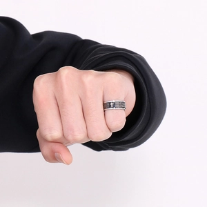 Mens vintage cross spinning ring in silver and black stainless steel on finger