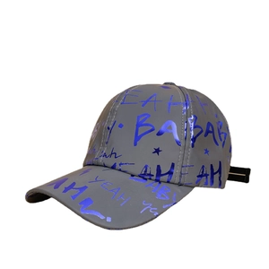 Detail of grey baseball cap with reflective blue graffiti lettering and shiny stars