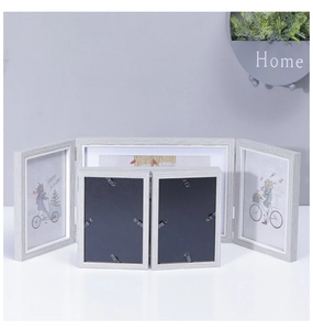 Detail of grey wood grain tri-fold photo frame set with metal hinges and back clips