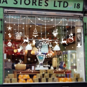 White Christmas window decals with Merry Christmas reindeer and snowflakes for shop decor