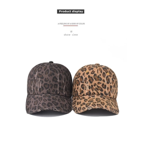 Detailed close-up of distressed leopard print baseball caps in grey and brown tones