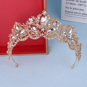 Macro view of crystal bridal crown with teardrop rhinestones on a red gift box