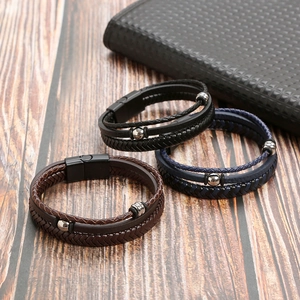 Men's retro braided leather bracelets with magnetic alloy buckles on wooden surface
