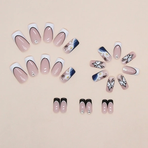 French press-on nails with butterfly motifs, 3D rhinestones and monochrome flower patterns