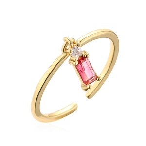 Gold plated open ring with square pink gemstone and clear zircon on white background