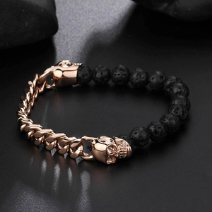 Detailed close-up of rose gold plated skull charms and black volcanic lava stone beads