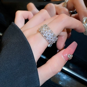 Detail of silver hollowed-out ring featuring zircons and retro palace-style design