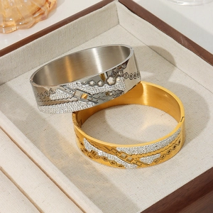 18K gold plated titanium steel bangle featuring hollow flower patterns and inlaid diamonds