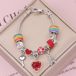 Silver charm bracelet with red heart, star and rainbow beads on a jewelry box