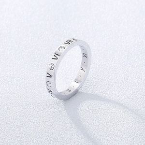 Detail of silver titanium steel ring with roman numerals and sparkling crystals
