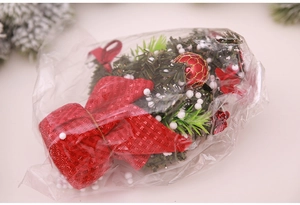 Detailed close-up of a 20cm artificial Christmas tree in protective clear packaging
