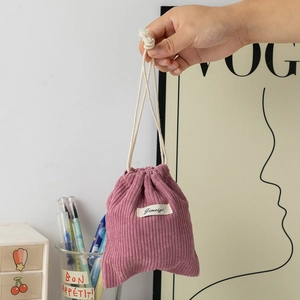 Detail of pink corduroy drawstring pouch showing soft fabric texture and cotton rope