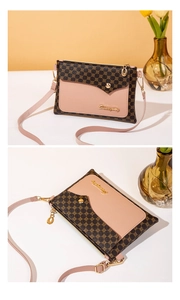 Detail of elegant small crossbody bag with circle print leather and gold logo hardware