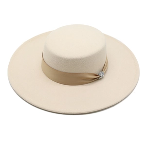 Detailed view of cream wool felt flat top hat with satin ribbon and rhinestone buckle