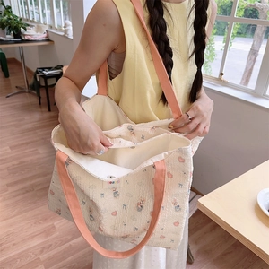 Detail of quilted canvas tote showing interior compartment and cute cartoon prints