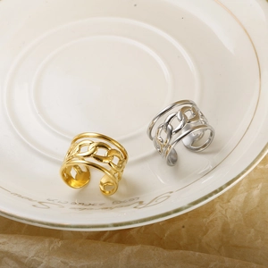 Minimalist interlocking chain rings in gold and silver finish on a decorative plate