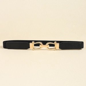 Close-up of black elastic belt with gold metal buckle and textured leather detail
