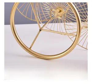 Close-up of a stable gold metal fruit basket base with a sleek radial wire design