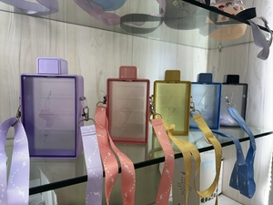 Detail view of colorful square plastic water bottles with lightning embossed patterns and straps