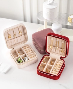 Macro view of velvet jewelry organizer featuring necklace hooks and ring slots