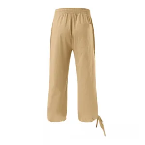 Detail of khaki cotton linen trousers showing drawstring waist and square back pocket